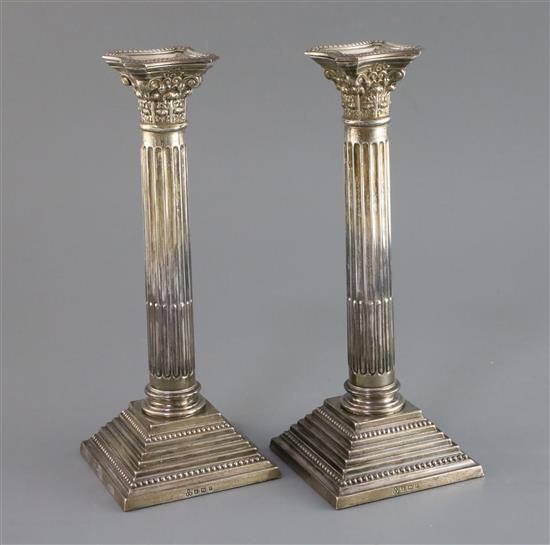 A pair of 1960s silver corinthian column candlesticks,